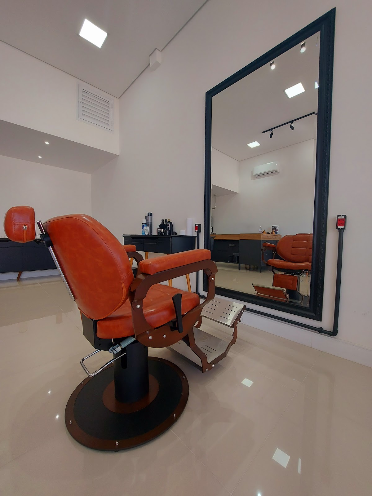 Poltrona de atendimento e espelho da Barbearia Voullo